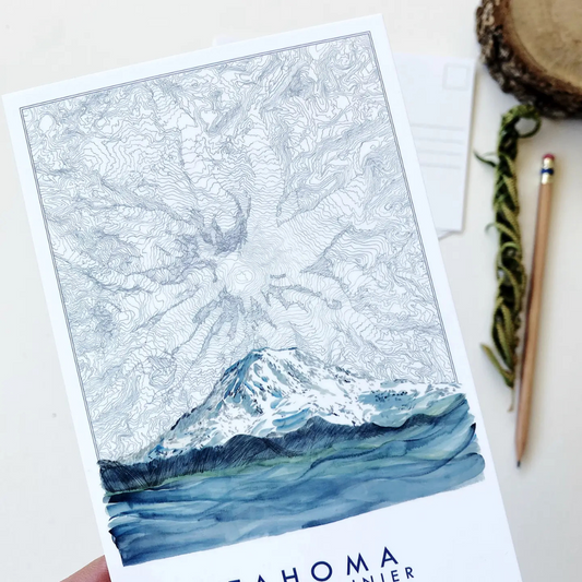 Postcard featuring Mount Rainier blended with a topographical view of Mount Rainier in several hues of blue. The words "TAHOMA MOUNT RAINIER" sit underneath it.