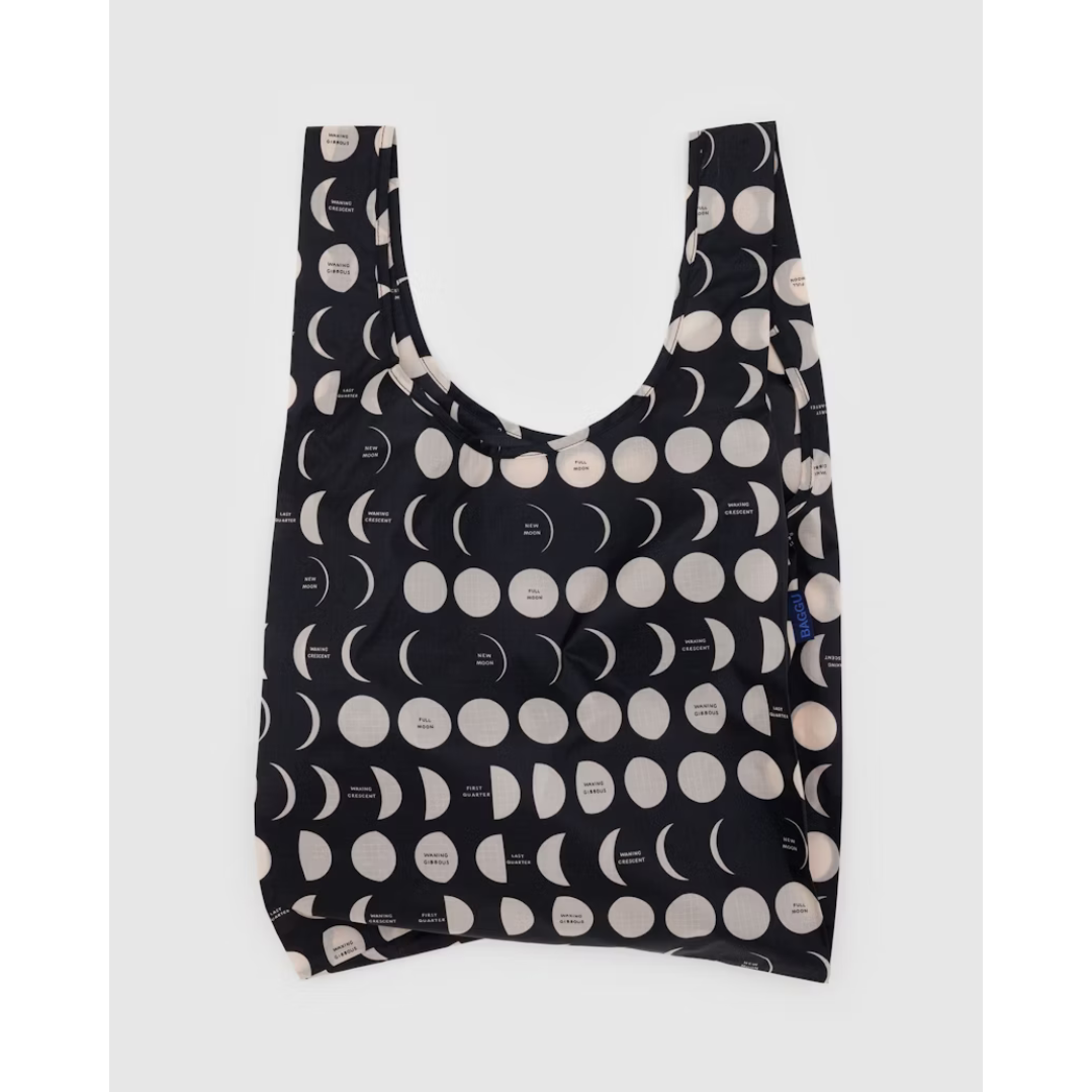 Black reusable tote bag featuring different phases of the moon in white.