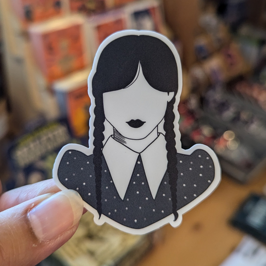 Sticker features bust of Wednesday Addams with two dark braids, dark lips and collared shirt