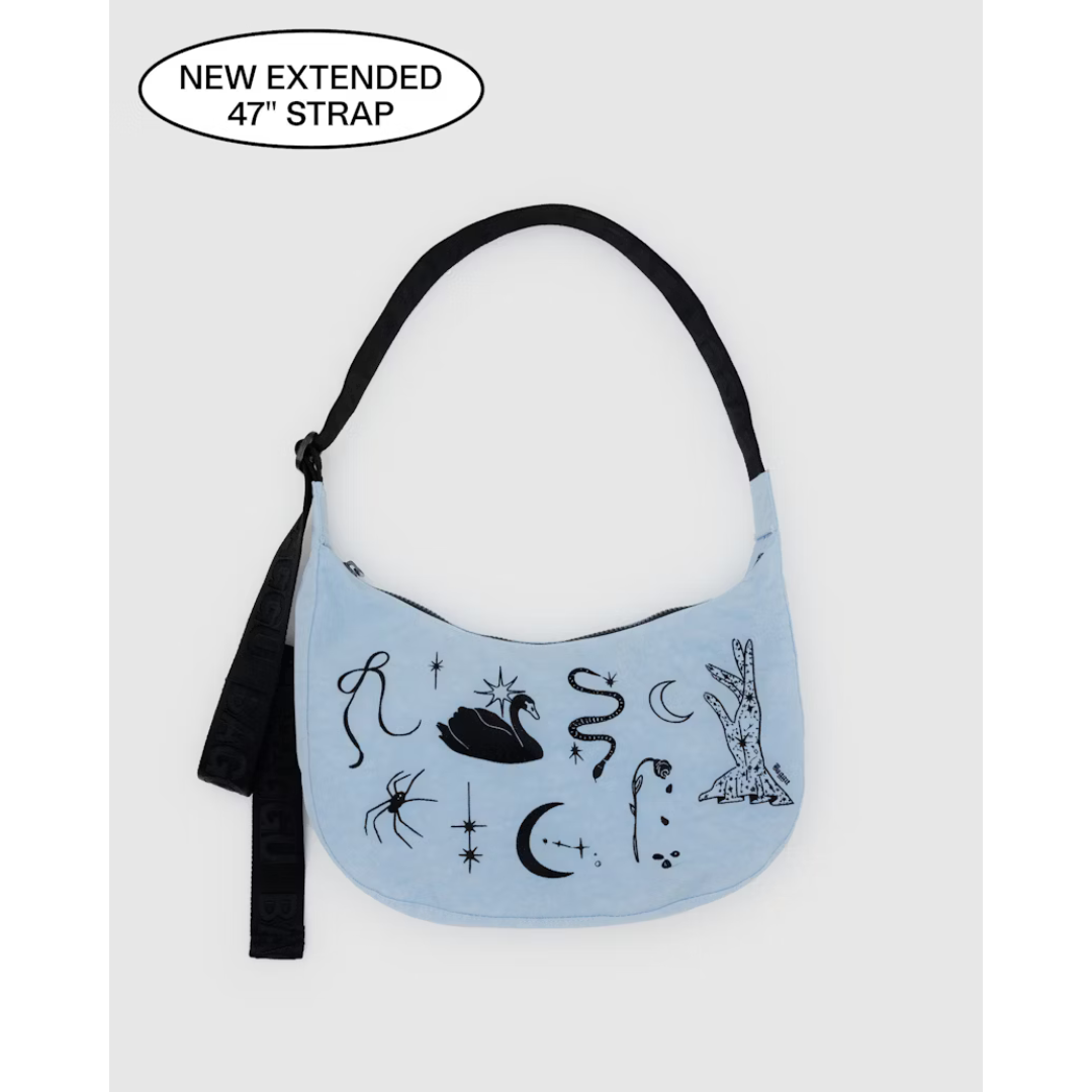 Baby blue nylon bag featuring black embroidery of a bow, a swan, a snake, a moon, a hand, a spider, stars and a rose. Also features a black strap.