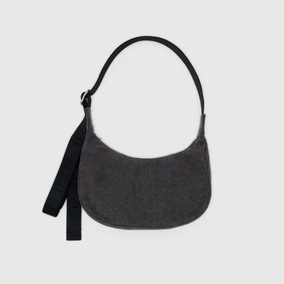 Crescent shaped dark gray denim shoulder bag with a black adjustable strap 