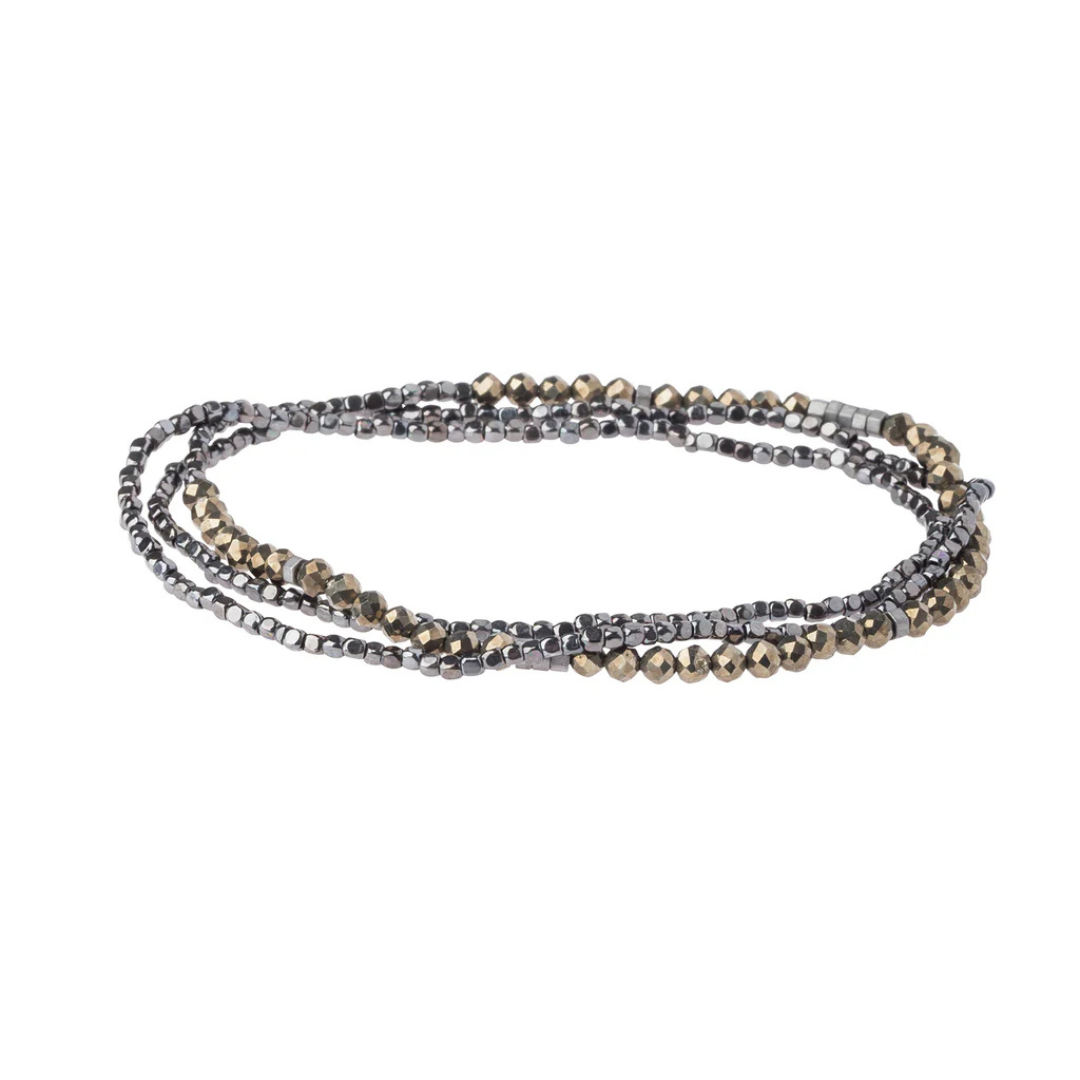 Triple banded bracelet features beads of gold and brownish black.