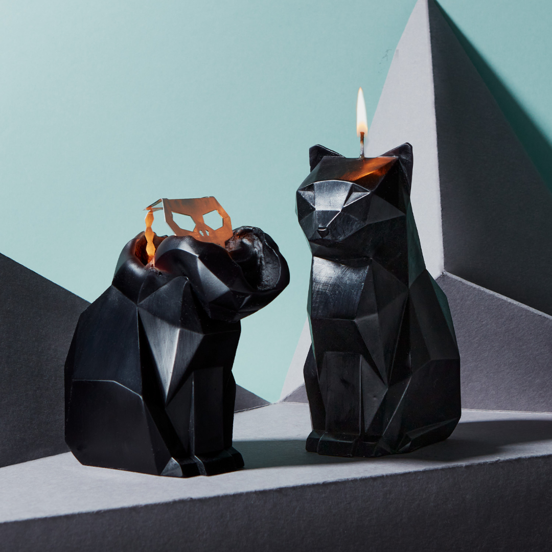 Black cat shaped candle shown in two different burn stages.