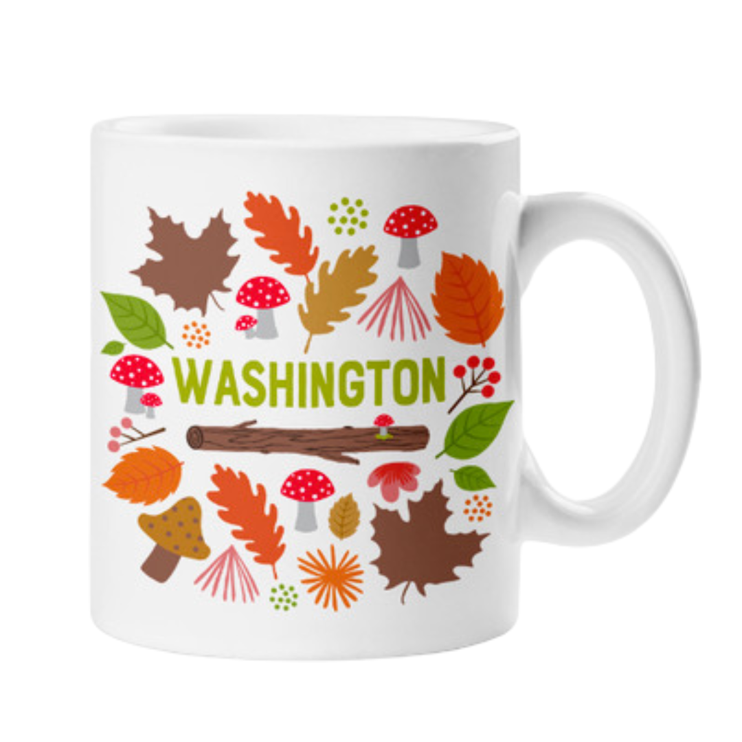 White mug with woodland theme of leaves, mushrooms, and branches that says "Washington"