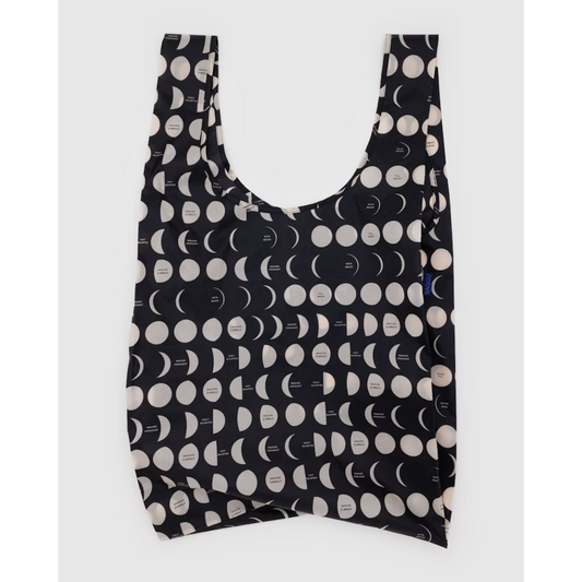 Large black reusable tote featuring an all over pattern of white moons in different phases.