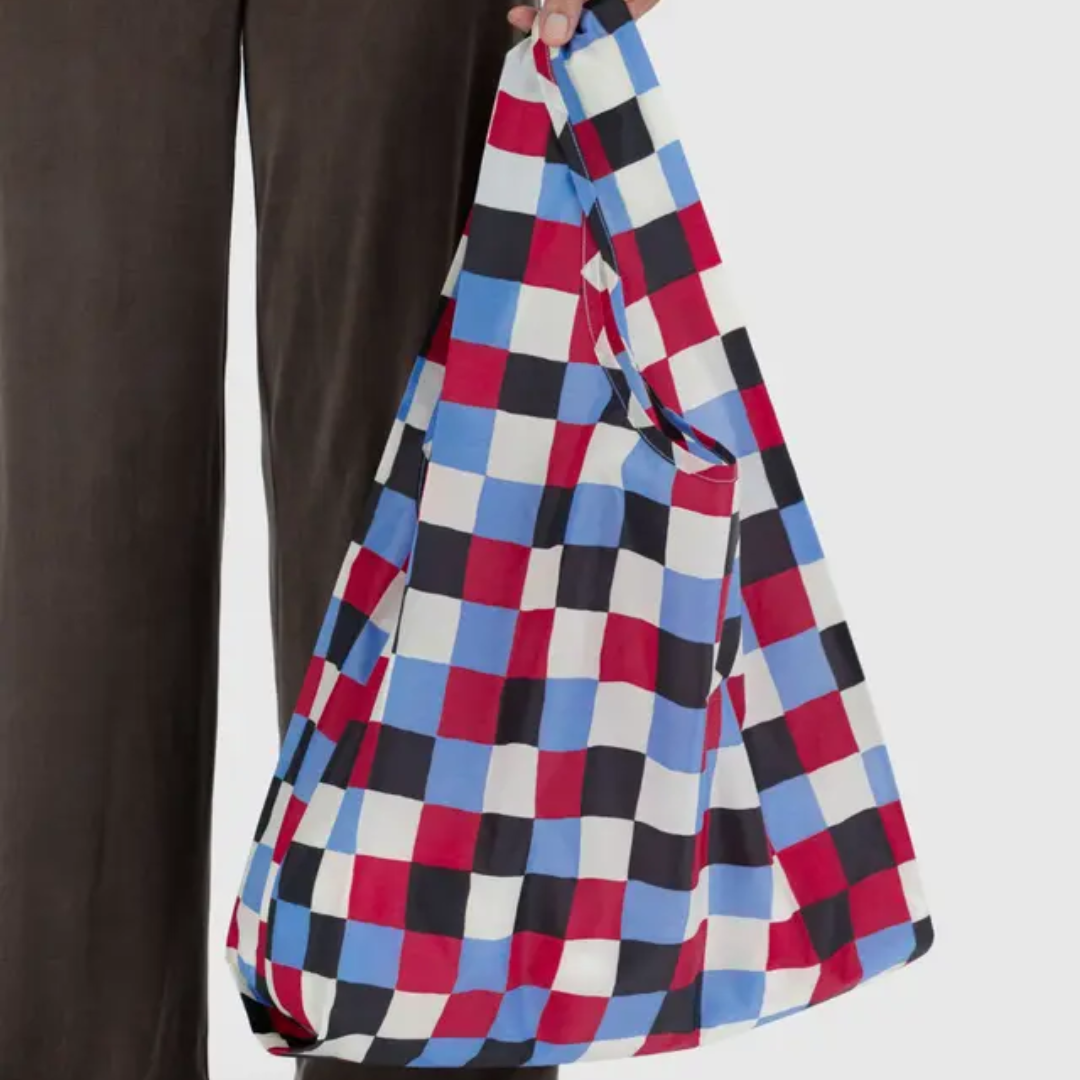 Model holding a multicolored checkered bag 