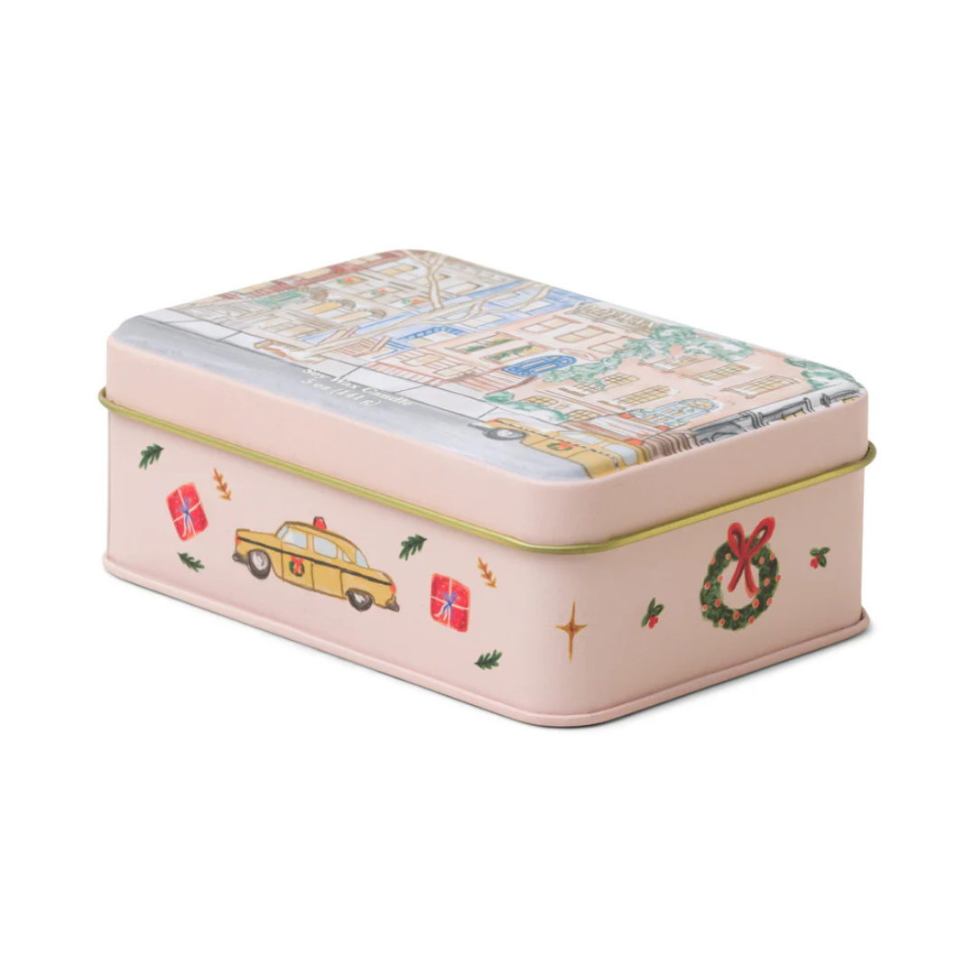 Pink holiday tin with gold piping decorated with red wrapped presents, mistletoe, wreaths and yellow taxis. 