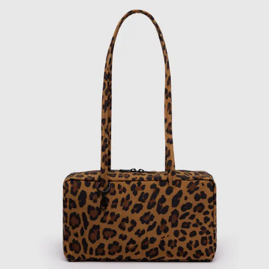 Baggu bowler bag is rectangular shaped with long straps. The bag is in a brown and tan leopard print