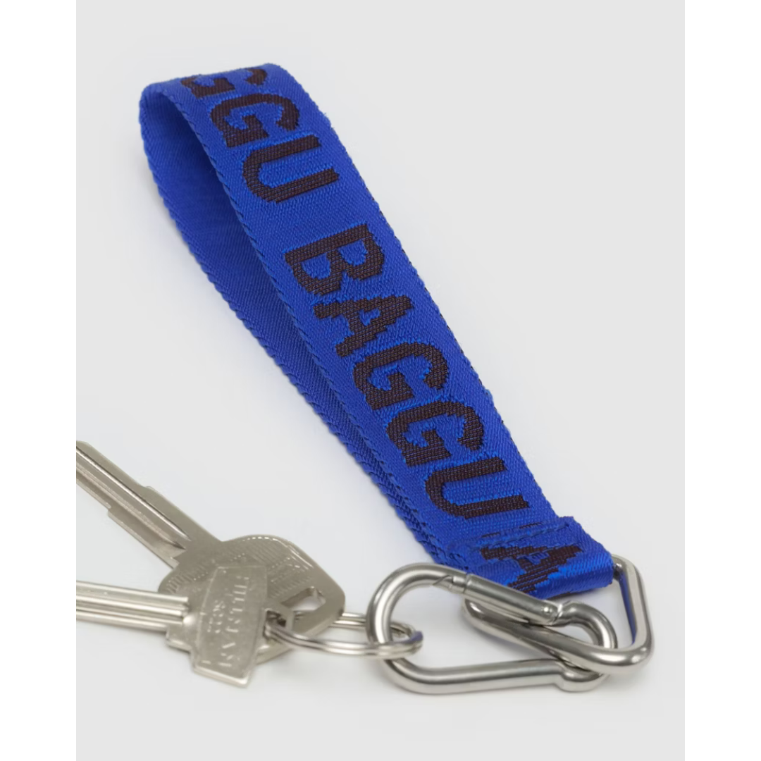 Bright blue lanyard featuring the word "BAGGU" in a darker blue font and a silver keychain and carabiner attached. 