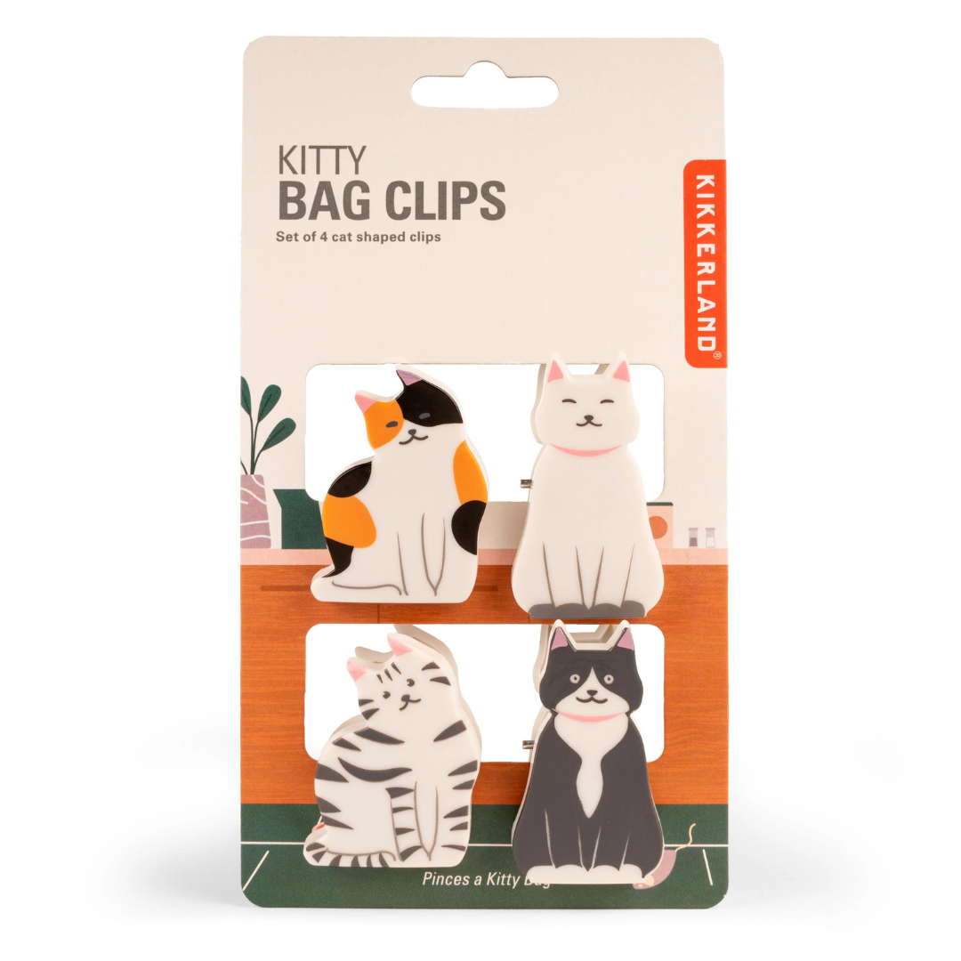 Four cats of the black, white and orange variety as clips on paper packaging featuring the words "kitty bag clips".