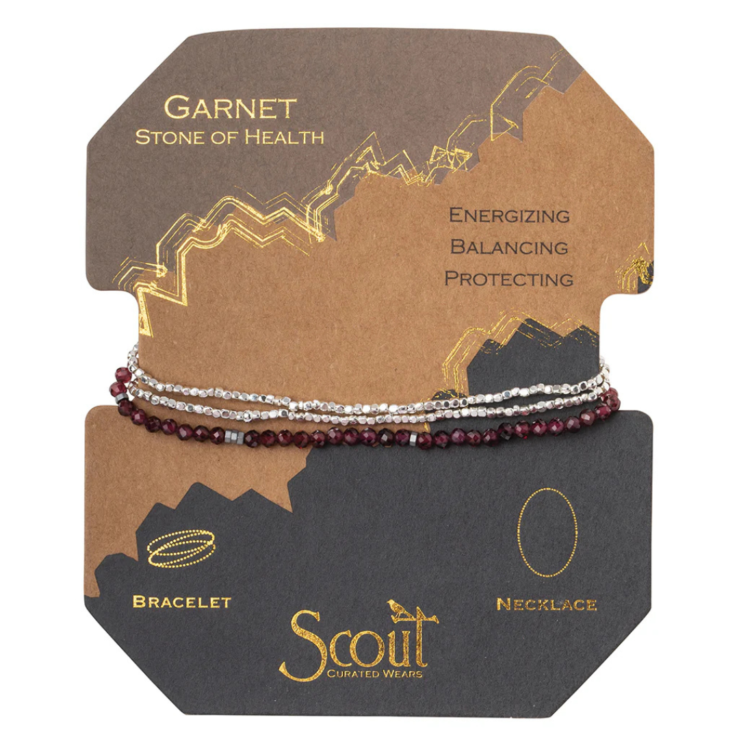 Triple banded bracelet featuring Garnet stones and silver beads against cardboard packaging.