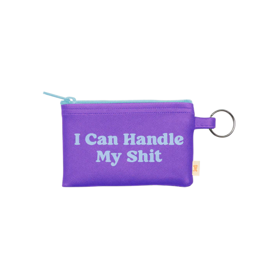 Purple pouch with a turquoise zipper and keyring reading "I can handle my shit"
