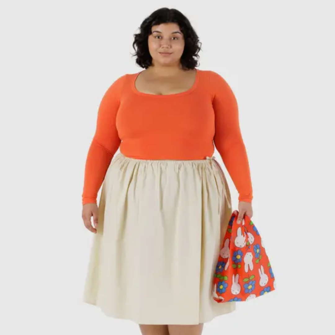Model holding small shopping bag