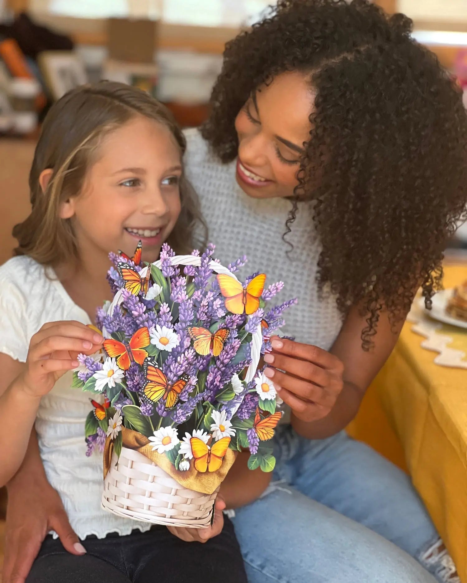 Adult and child models hold the pop-up bouquet.