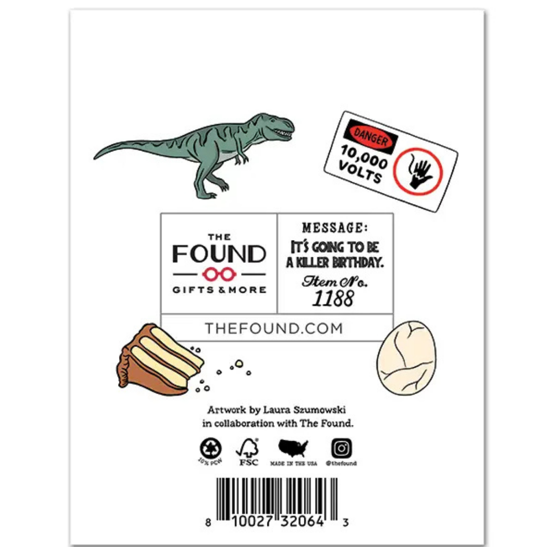 back of card has illustrations of a t-rex, a warning sign, chocolate frosted cake, and a cracked egg
