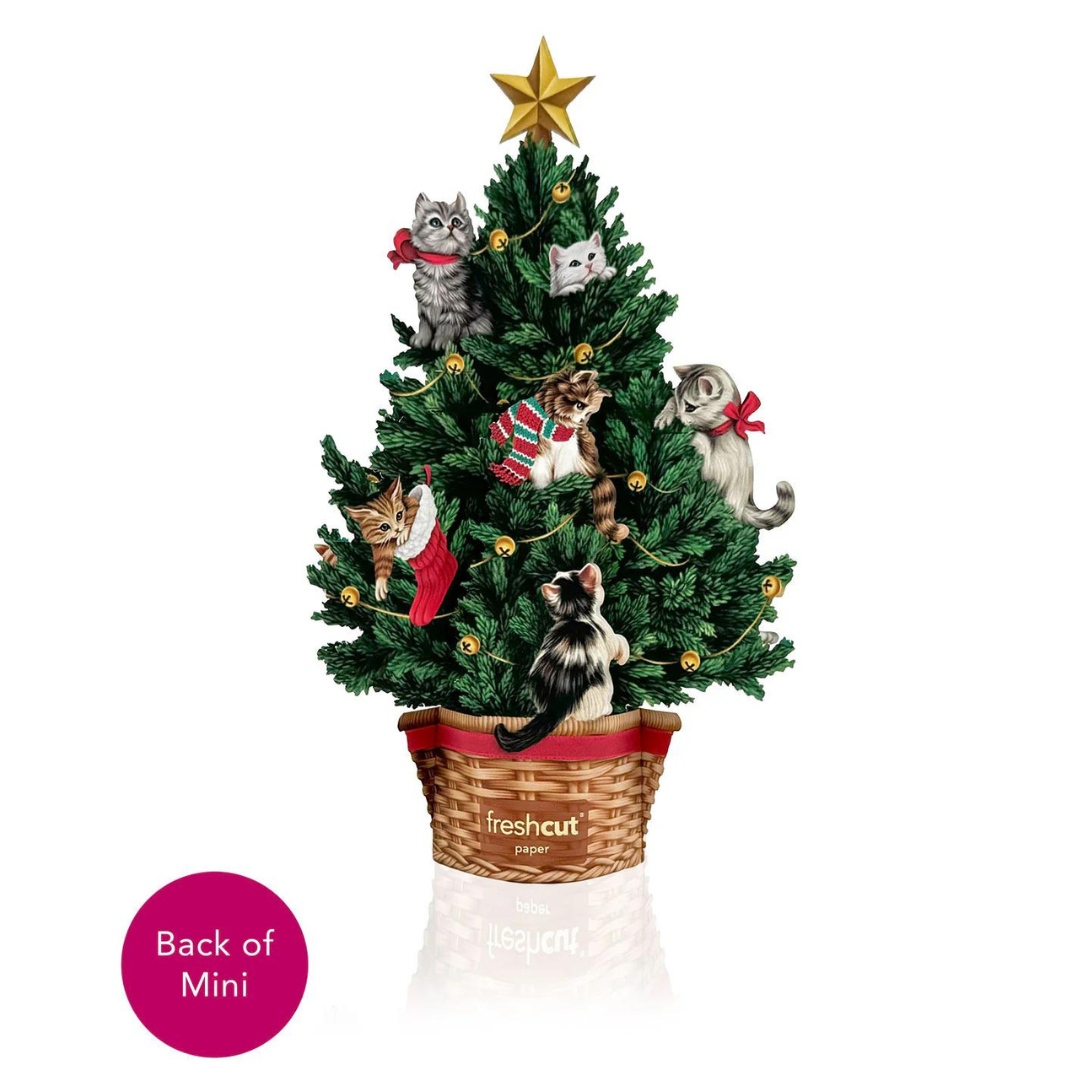 Mini Christmas tree filled with bells, stockings and kittens, topped with a gold star and all in a basket with a red bow. 