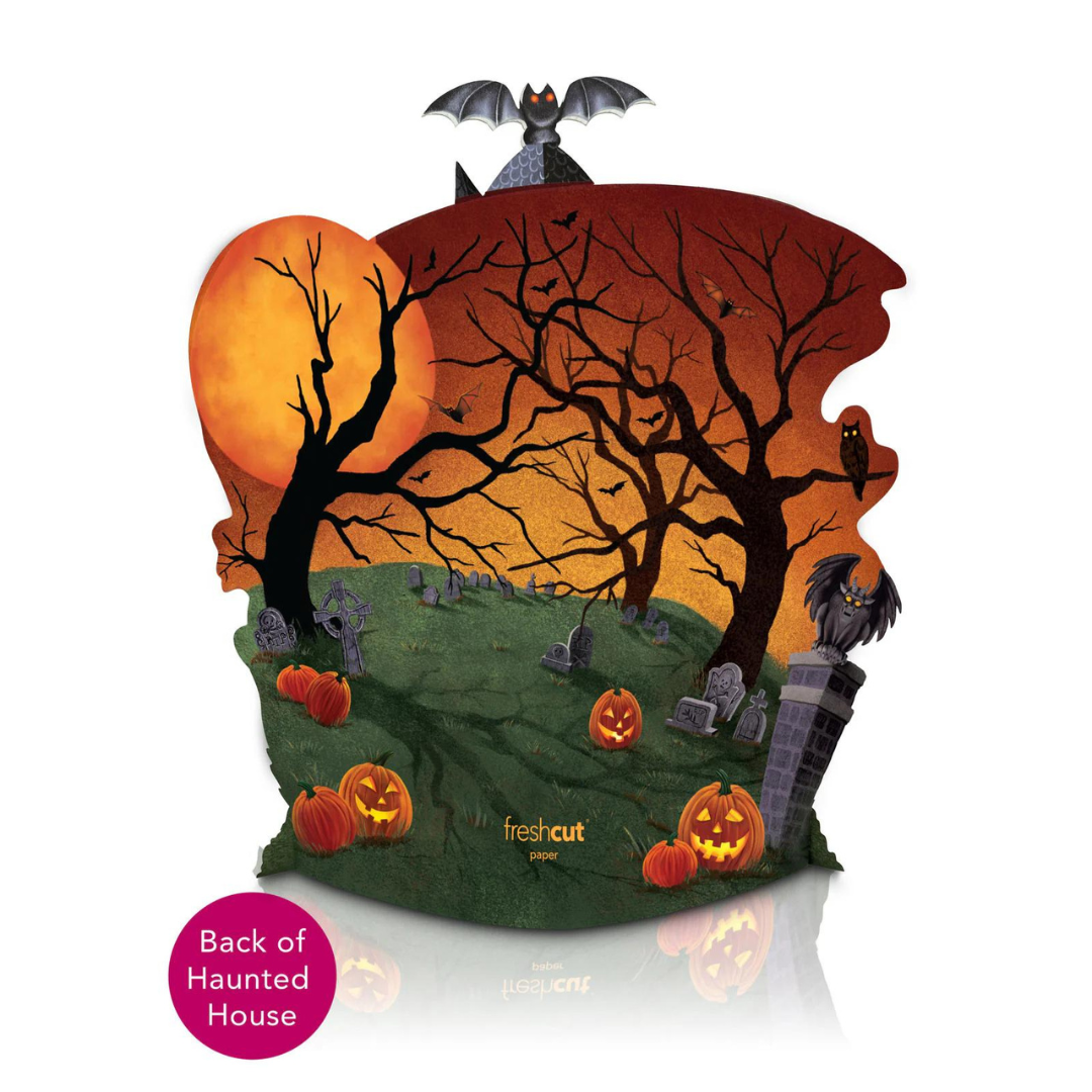 Back of haunted house pop-up card which features a cemetery with jack-o-lanterns, spooky trees, owls and bats and a Halloween night sky.