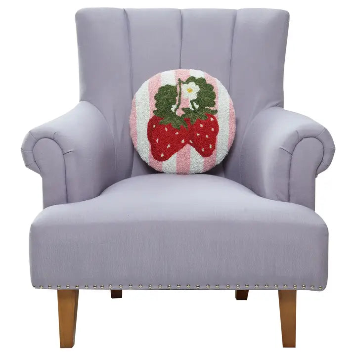 Striped strawberry pillow on a chair for scale.