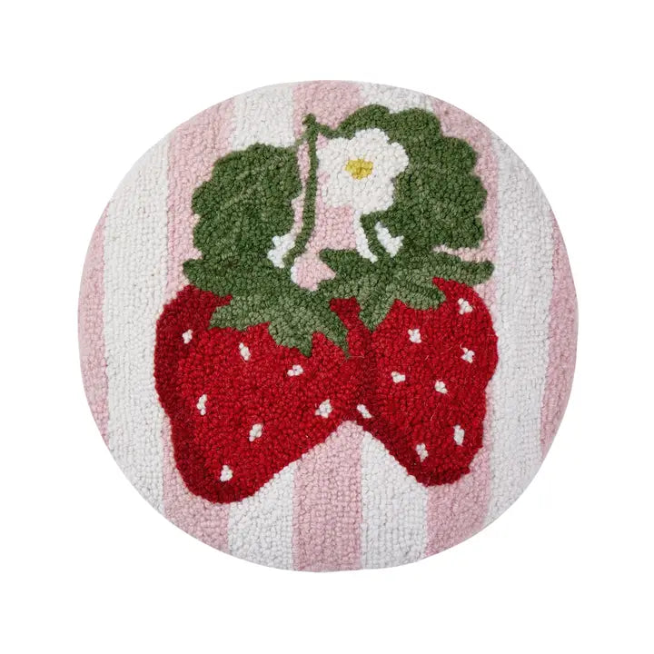 Round wool hook pillow has a boucle texture with two ripe strawberries, leaves and a blossom against a pink and white striped background