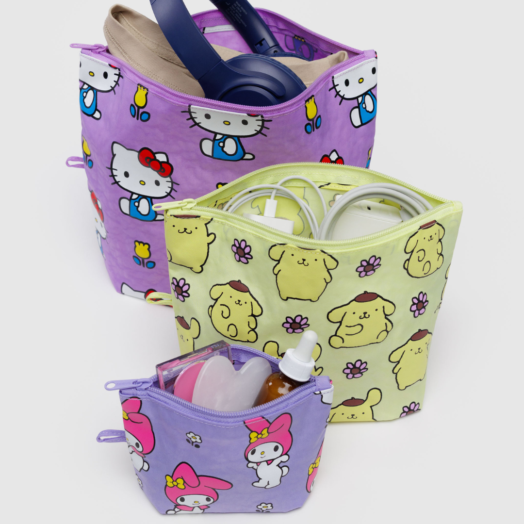 Pouches packed to show usefulness. Large holds headphones and a shirt, medium has charging equipment, and small has cosmetics.