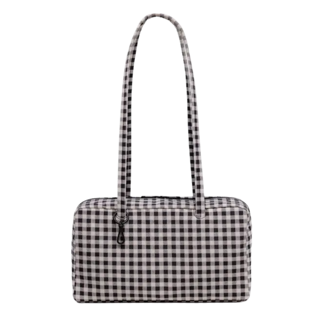 Rectangle shaped bag with long shoulder straps and a clip at the base of the strap to hang accessories. Bag is black and white gingham.