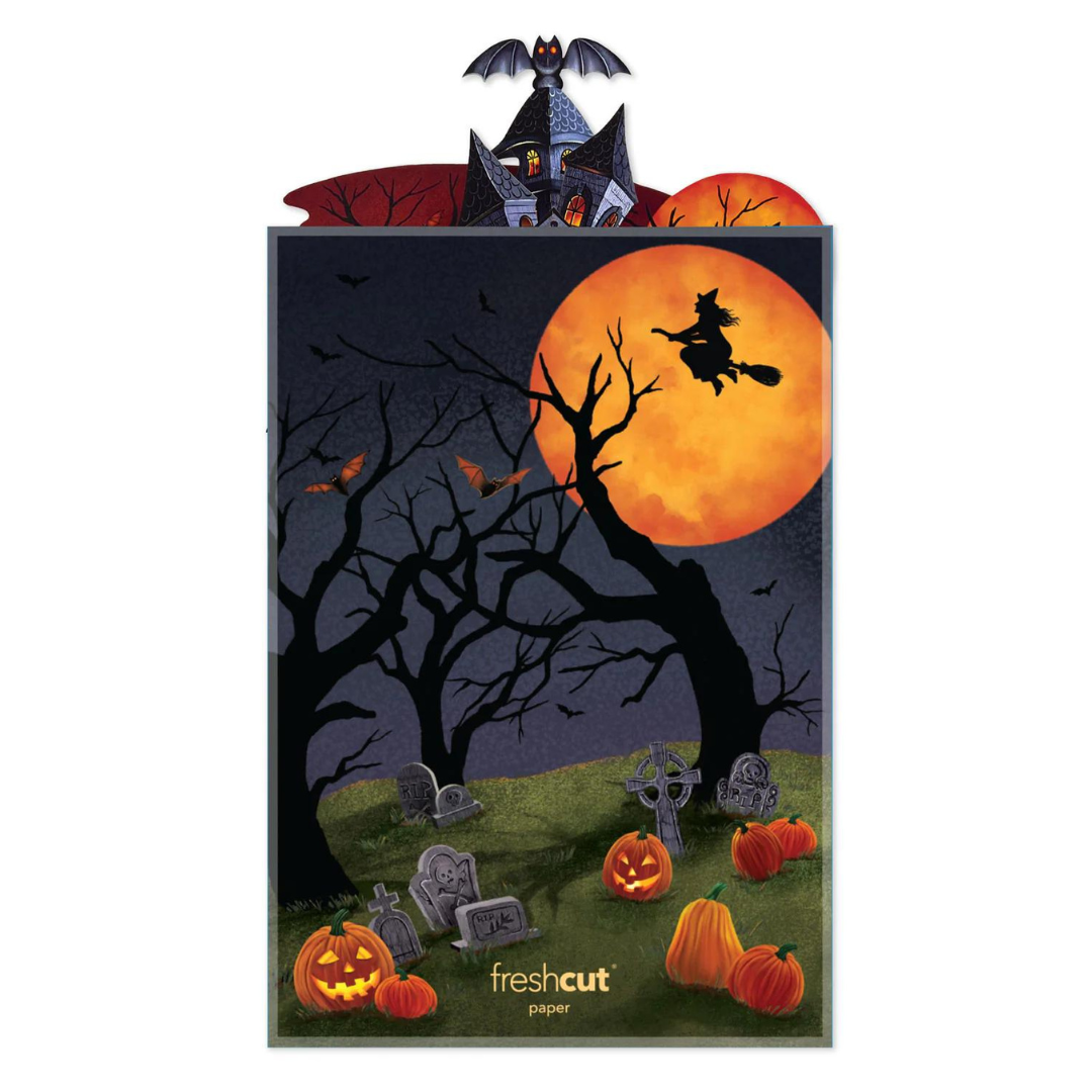 Side of pop-up card featuring a cemetery with jack-o-lanterns, spooky trees, bats, a witch flying in front of an orange moon, all surrounded by a dark night sky.