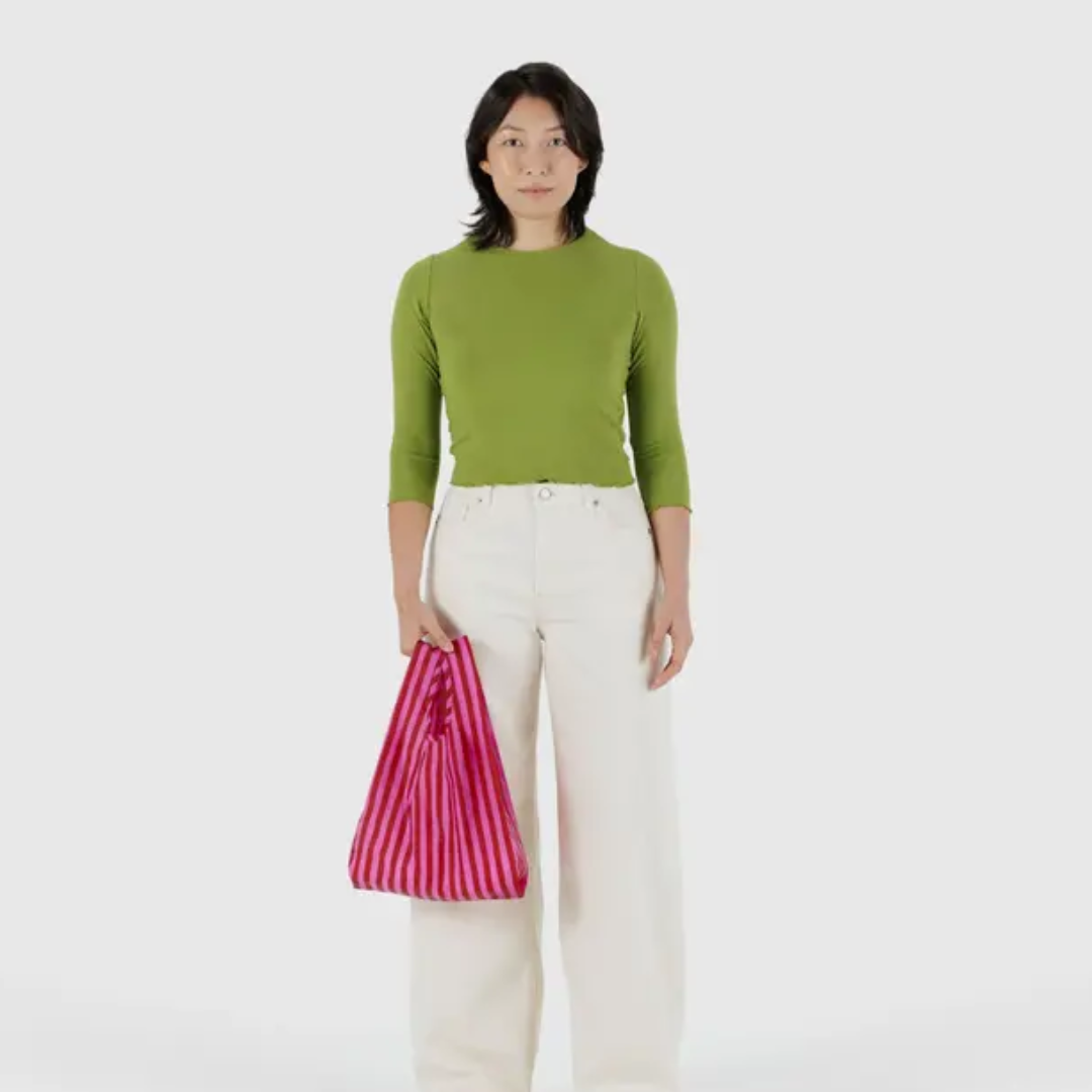 Model holding the small shopping bag