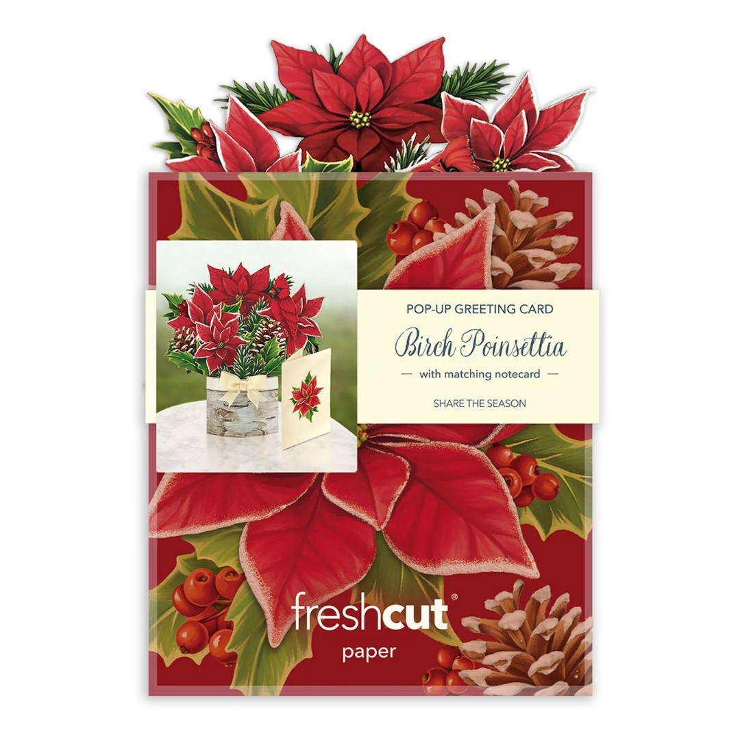 Packaging of a red poinsettia greeting card featuring beautiful red poinsettias, green leaves and pinecones against a white background.