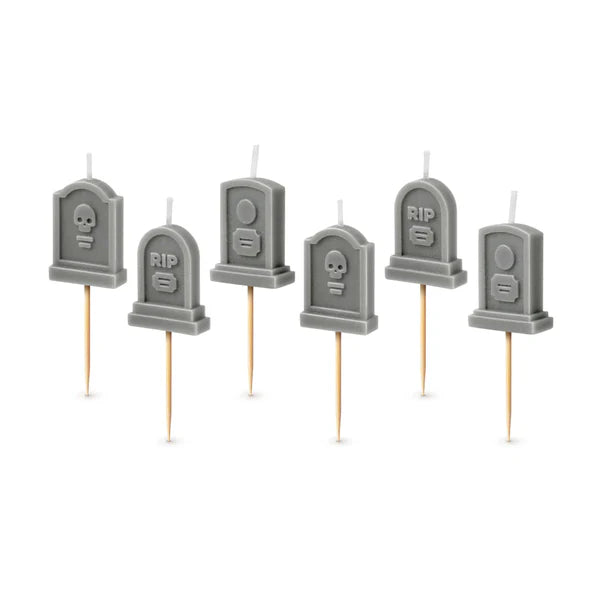 Set of six gray tombstone-shaped candles on toothpicks