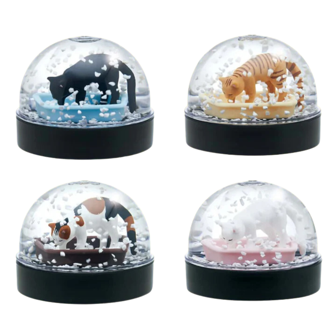 Four small snow globes featuring cats in litter boxes.