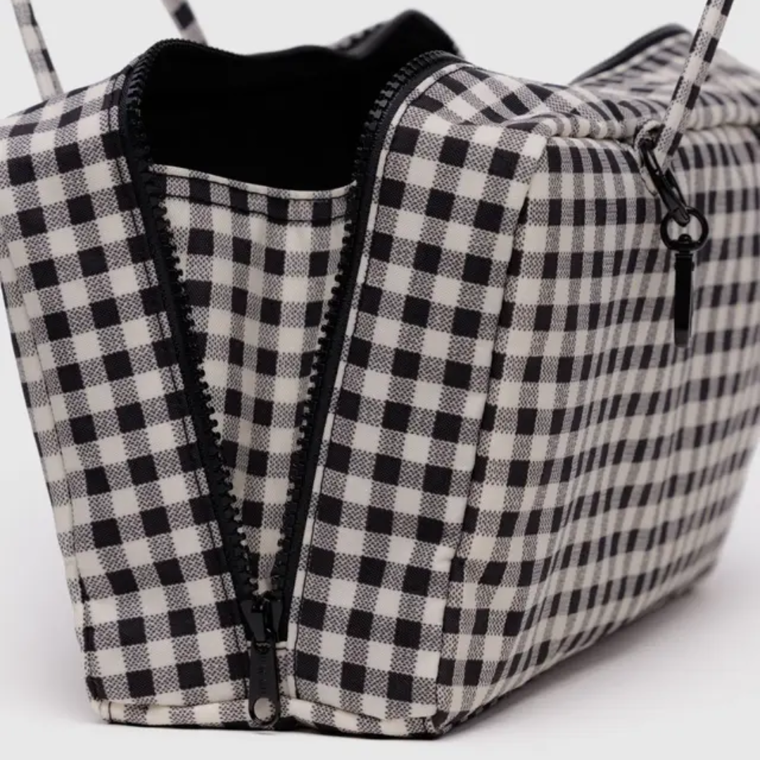 Detail of open bag shows a side gusset inside the zipper to maximize storage.