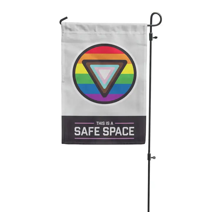 Garden flag on metal stand featuring inclusive circular pride flag and text that says "This is a safe space"
