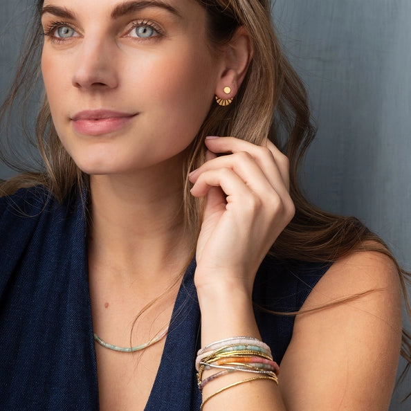 Woman wearing earrings with ear jackets