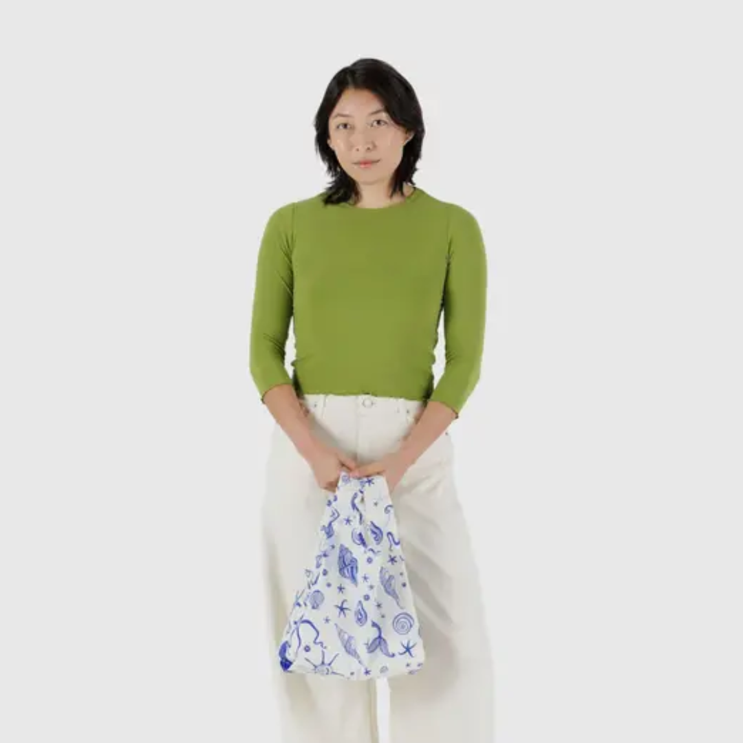 Model holding the small shopping bag