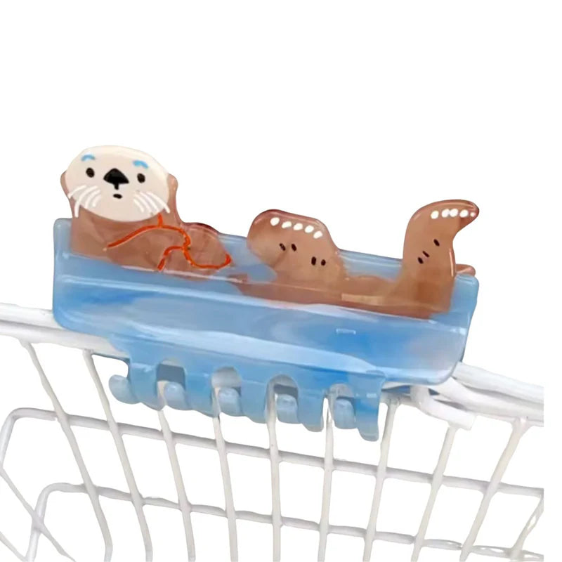 Claw hair clip in the shape of an otter floating in water.