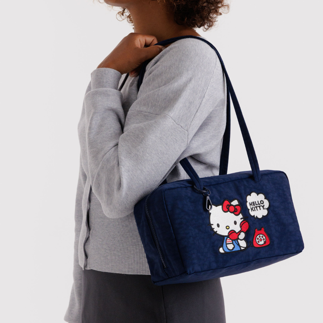 Model wears the Hello Kitty bag on their shoulder