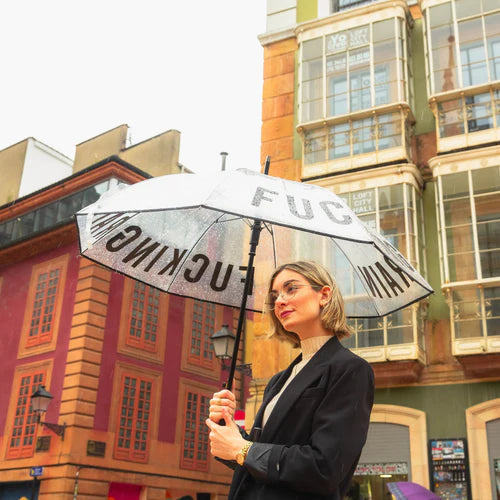 Model holding the umbrella on a city street