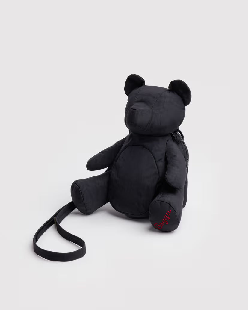 Black teddy bear purse with a strap on a white background