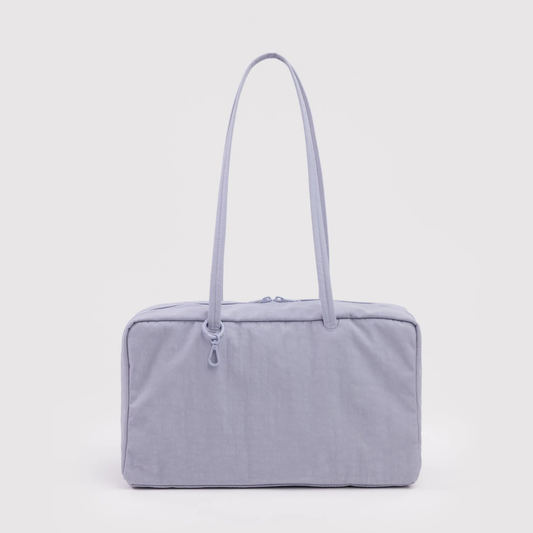 Light gray handbag with a strap on a light gray background