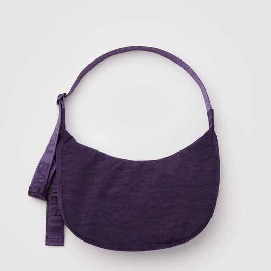 Purple bag with a strap on a light gray background