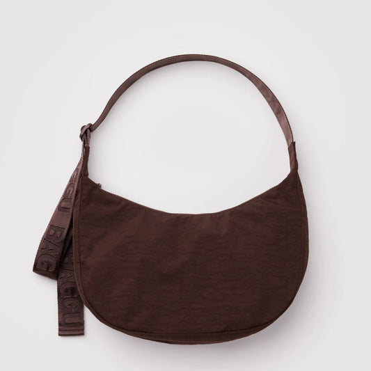 Brown handbag with a strap on a light gray background