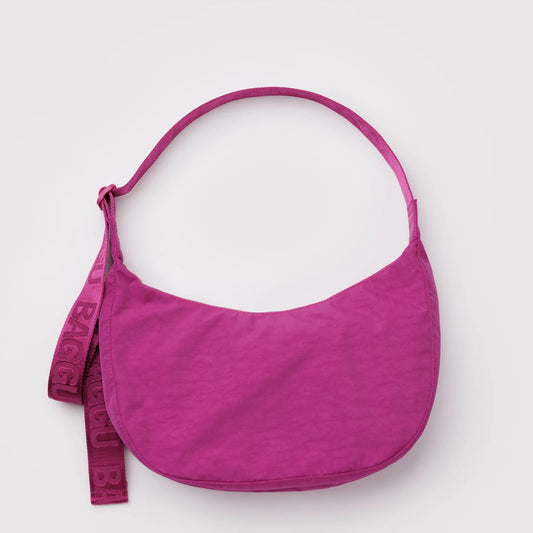 Deep Fuchsia purse with a strap on a white background
