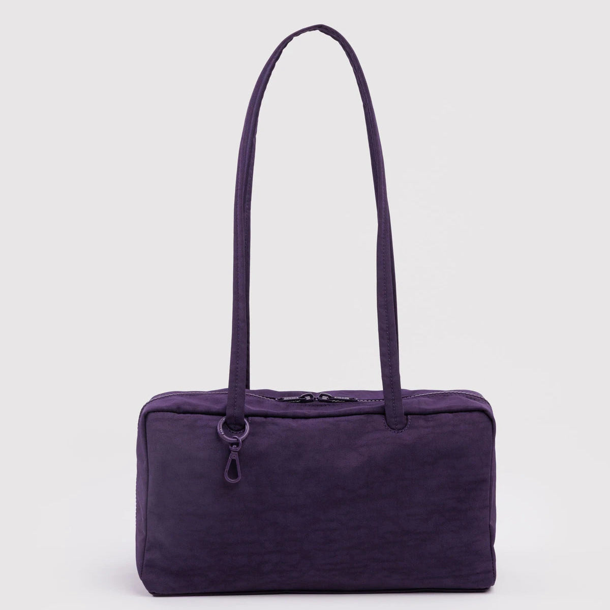Purple handbag with a strap on a light purple background