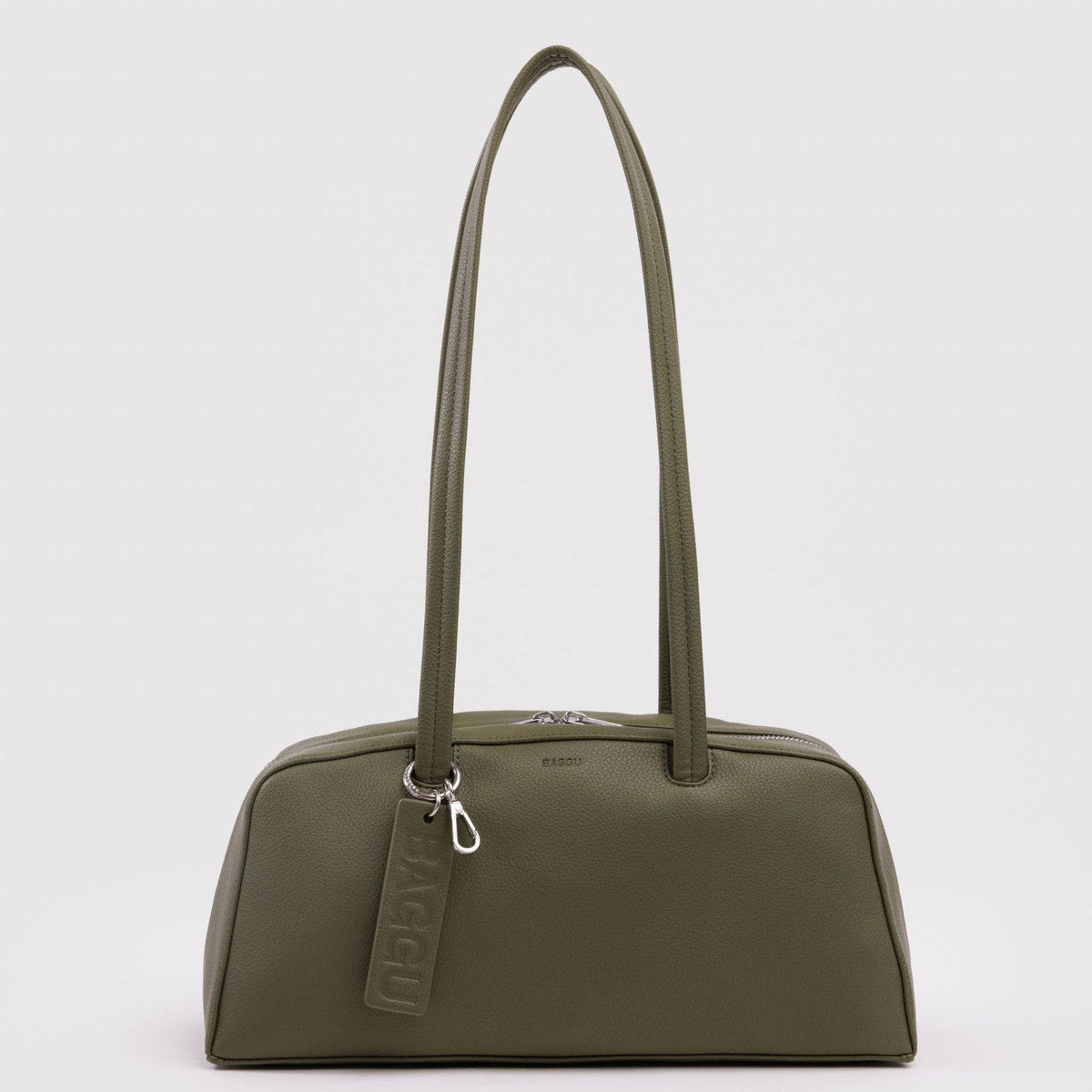 Green handbag with a visible brand tag on a light gray background