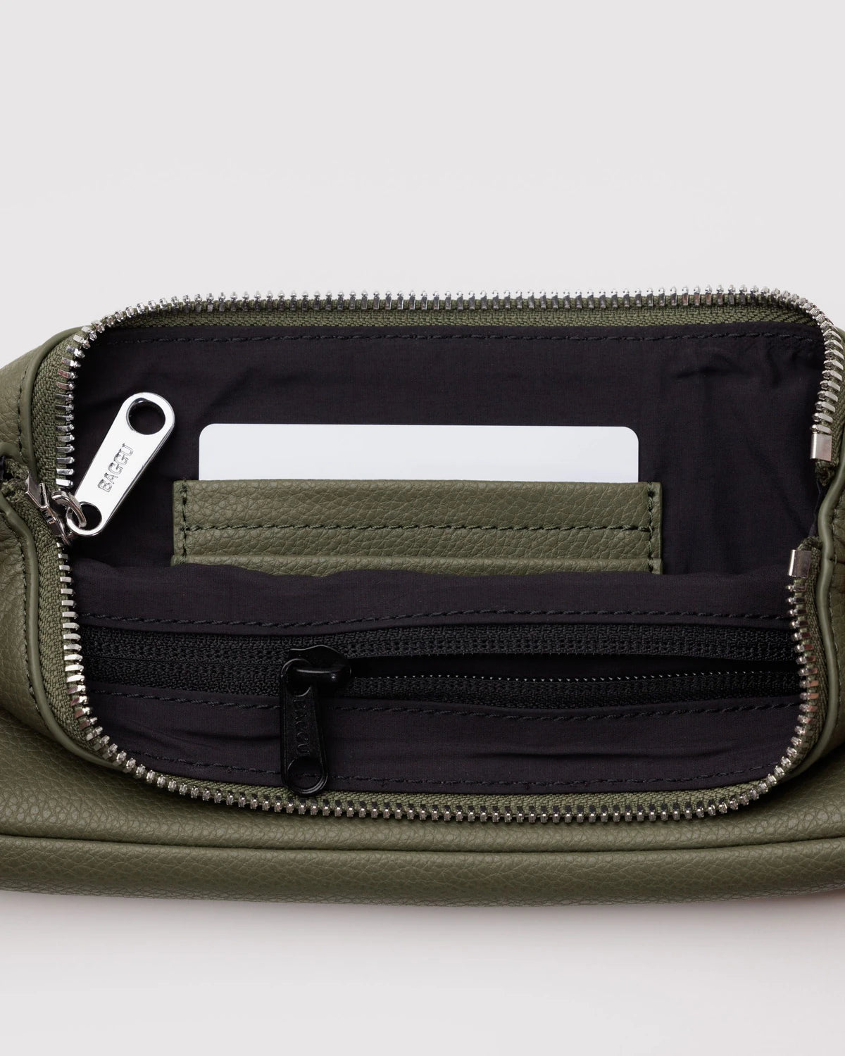 Green pouch with multiple compartments on a light gray background