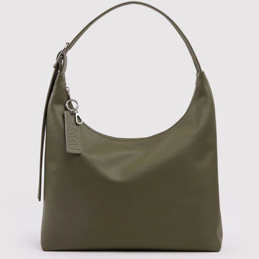 Green handbag with a visible brand tag on a light gray background
