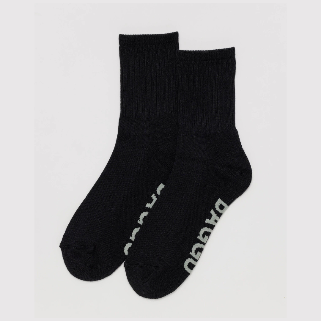 Pair of black socks with a brand logo on a light gray background