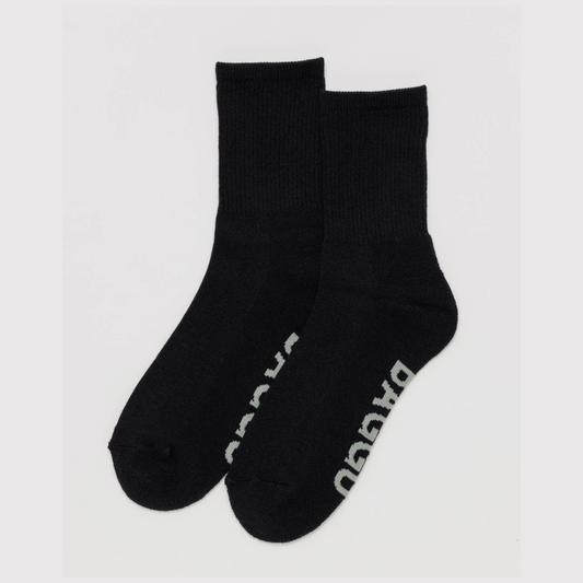 Pair of black socks with a brand logo on a light gray background