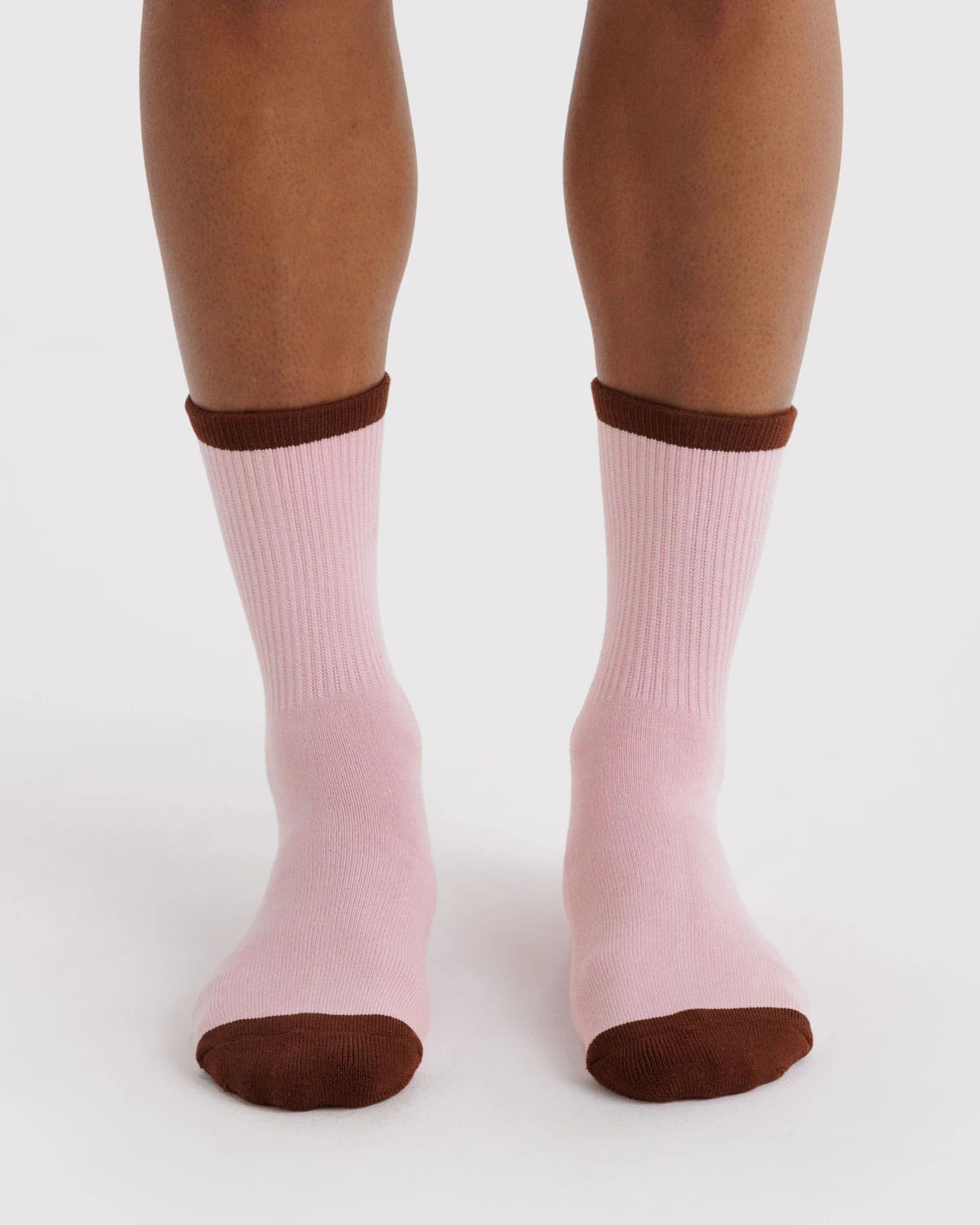 Pink socks with brown tops and toes on a white background