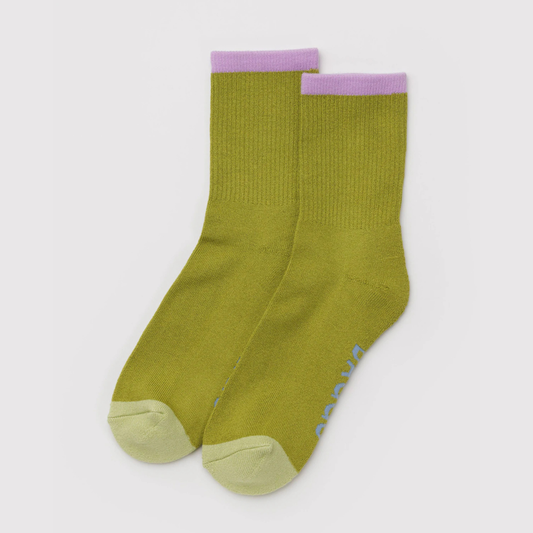 Pair of green socks with purple accents on a light gray background